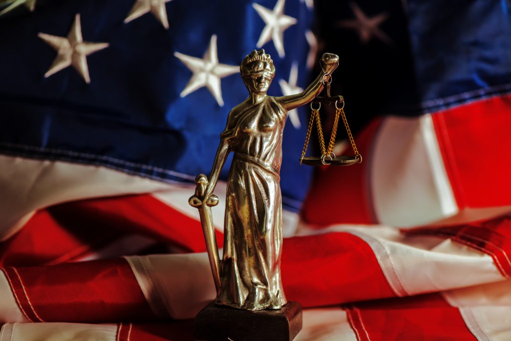 Statue in front of American flag - mediation services concept image
