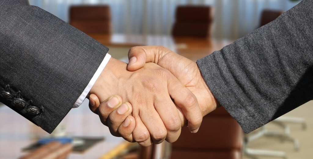 shaking hands - mediation vs arbitration concept